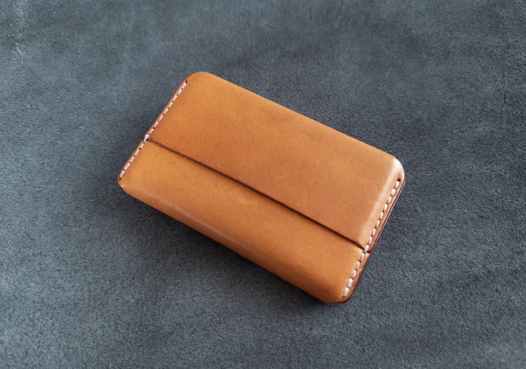 Front view of the wallet made from Weathered natural leather with white stitching